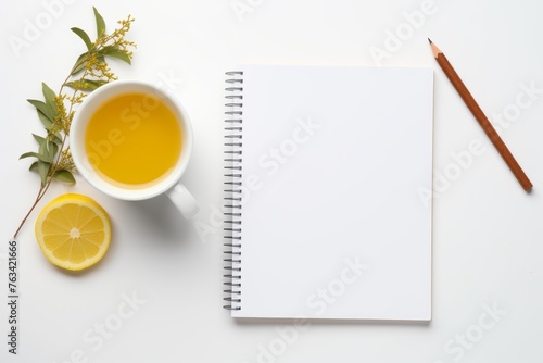 Cup of tea, lemon, and pencil on a table