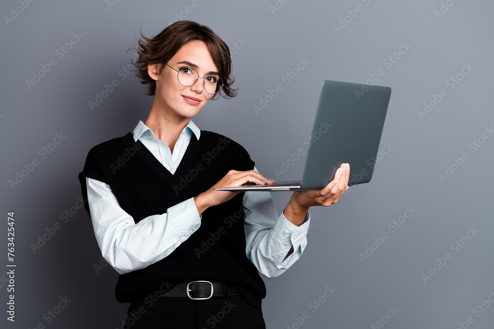 Photo of adorable young woman entrepreneur wear trendy black clothes use modern device netbook isolated on grey color background - obrazy, fototapety, plakaty 