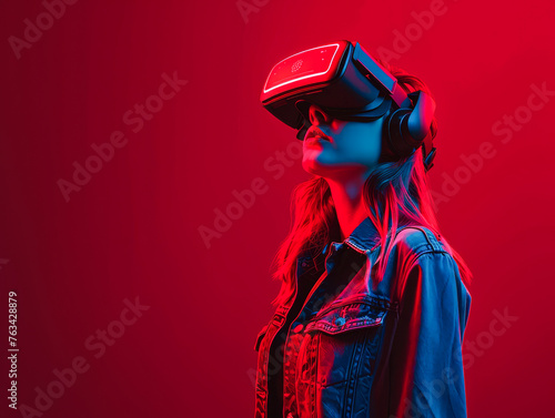 A woman wearing a virtual reality headset is standing in front of a red background. Concept of excitement and anticipation as the woman prepares to enter the virtual world