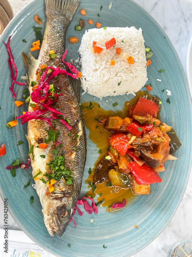 full fish cooked on plate french cuisine france culinary experience food tour travel foodie instagram worthy rice european cooking photo