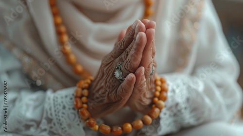 A close-up of hands in prayer, holding a rosary, with a soft focus on the Eid outfit and prayer cap, capturing the spirituality of Eid al Fitr