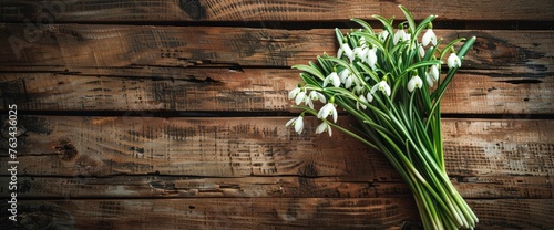 A cluster of white flowers placed on top of a wooden table