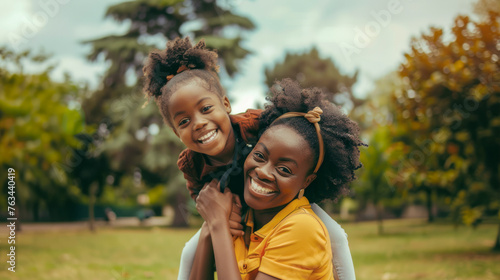Happy african mother having fun with her daughter outdoor  - Family people and mother's day concept - Models by AI generative
