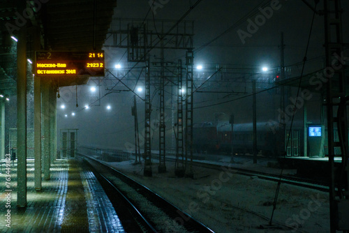 Railway station at night during snowfall