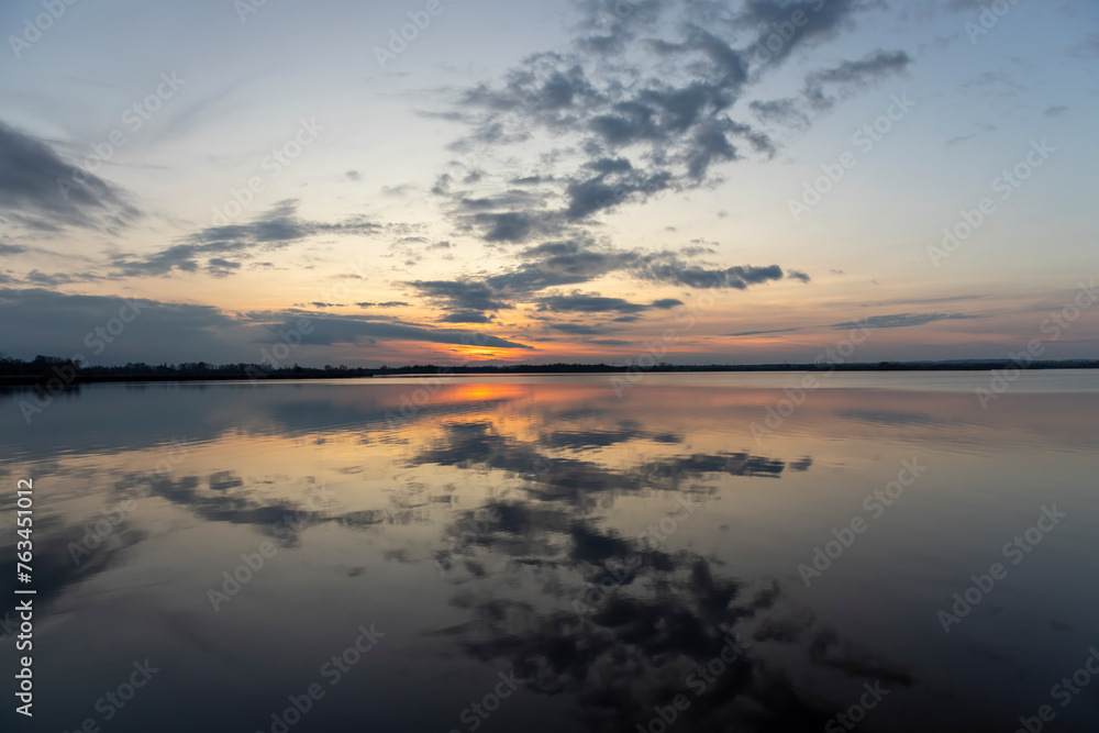 reflection of the sky in the lake at sunset