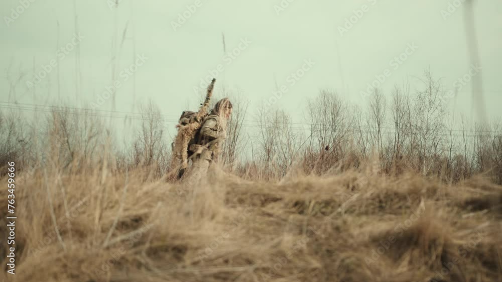 Sniper Rifle Environment With a steady stride, a female sniper traverses the rugged natural ...