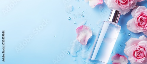 A bottle of water with roses on blue background