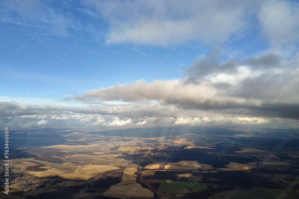 Aerial view from high altitude of earth covered with puffy rainy clouds forming before rainstorm Aerial view from high altitude of earth covered with puffy rainy clouds forming before rainstorm