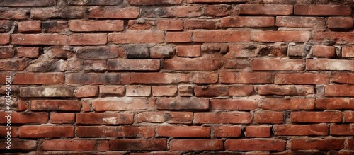 A brick wall with a small hole in the middle