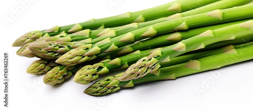 Fresh asparagus spears on white surface