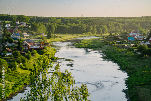 Rustic Village Scene: River and Hanging Bridge © nik_yurginson