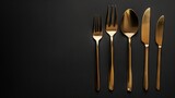 A lavish frame of golden fork, knife, and spoon against a sleek black background, exuding sophistication in dining
