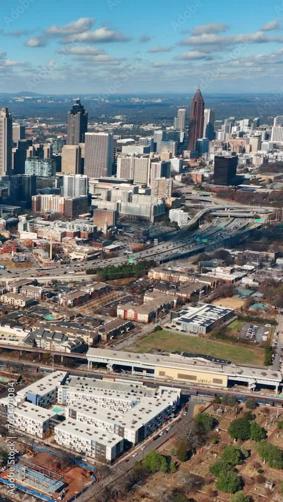 A view of the city of Atlanta from above. The central part of the city with skyscrapers and an interstate highway with heavy traffic. Aerial vertical video. A view of the city of Atlanta from above. The central part of the city with skyscrapers and an interstate highway with heavy traffic. Aerial vertical video.