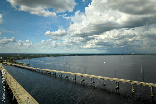 Barron Collier Bridge and Gilchrist Bridge in Florida with moving traffic. Transportation infrastructure in Charlotte County connecting Punta Gorda and Port Charlotte over Peace River