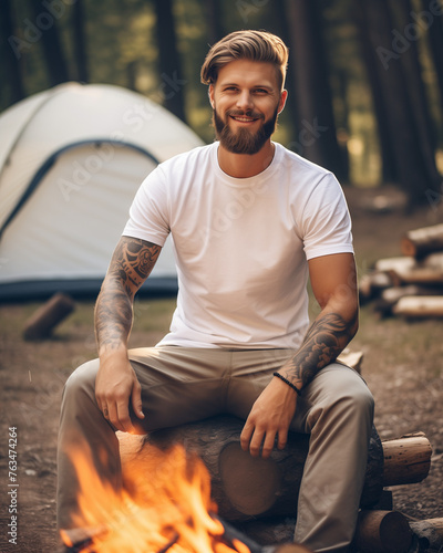 Male model posing outdoors with plain white canvas t-shirt mockup © JoelMasson