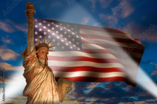 Statue of Liberty Enlightening the World with American Flag and Dramatic Sky American flag, USA.