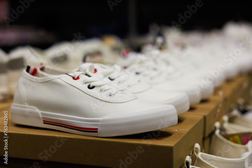 Canvas shoes were lined up on the store shelves. Men elegant shoes in a man clothing boutique. Shoes trade show.
