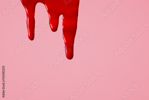Blood on pink background. First menstrual period concept, menstruation cycle period photo