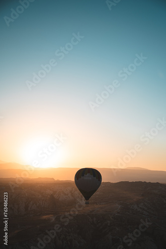 Sunrise with Hot Air Balloons over the epic Goreme, Cappadocia (Kapadokya) National Park, with orange skies and rock formations sunshine