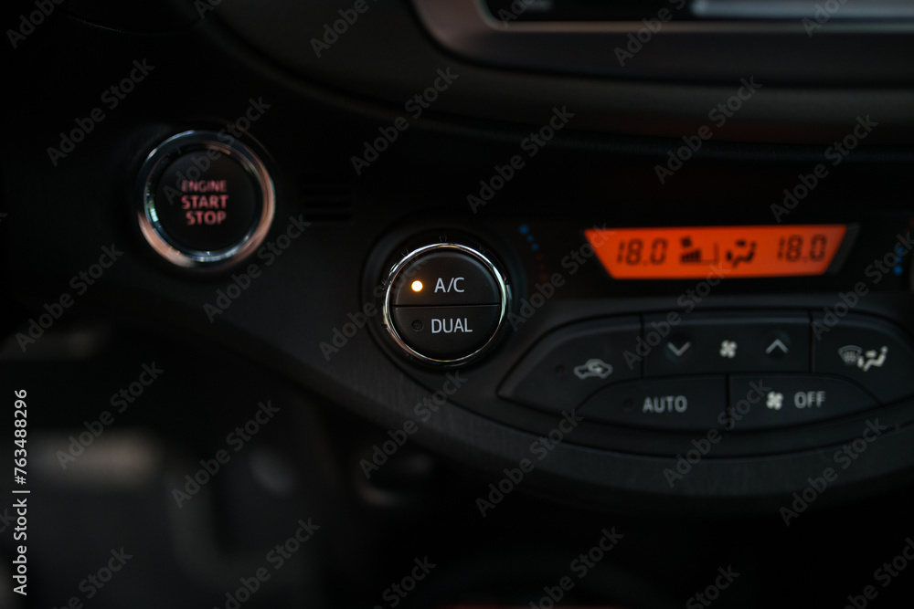 Car air conditioner button close up on black panel