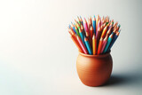 Colorful pencils folded in a vase. Space for text.
