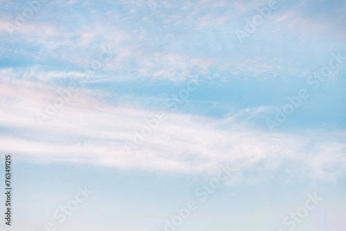 A beautiful sky tinted by the sun leaving vibrant shades of gold, pink, blue and multicolored. Clouds in the twilight evening and morning sky. Cloudy sky background in the evening and during the day.