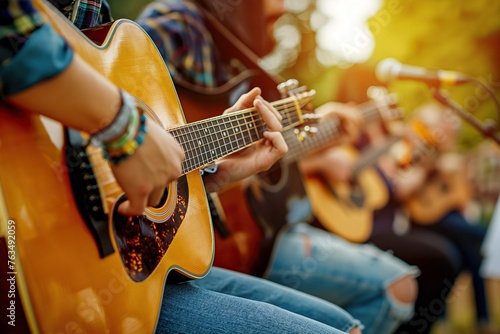 Musicians play guitars during a live performance at a cozy outdoor festival