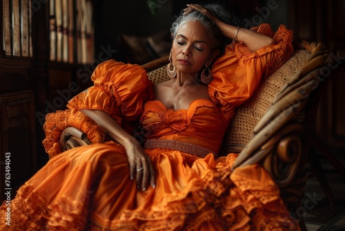 Woman in Orange Dress Sitting in Chair