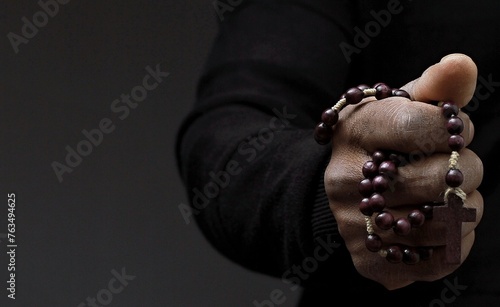 man praying to god with hands together on dark background stock photo 