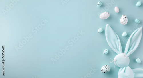 Easter background in pastel blue  Easter eggs and rabbit ears. Copy space