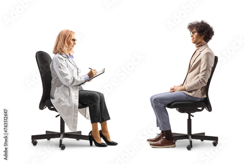 Professional man sitting and talking to a female doctor