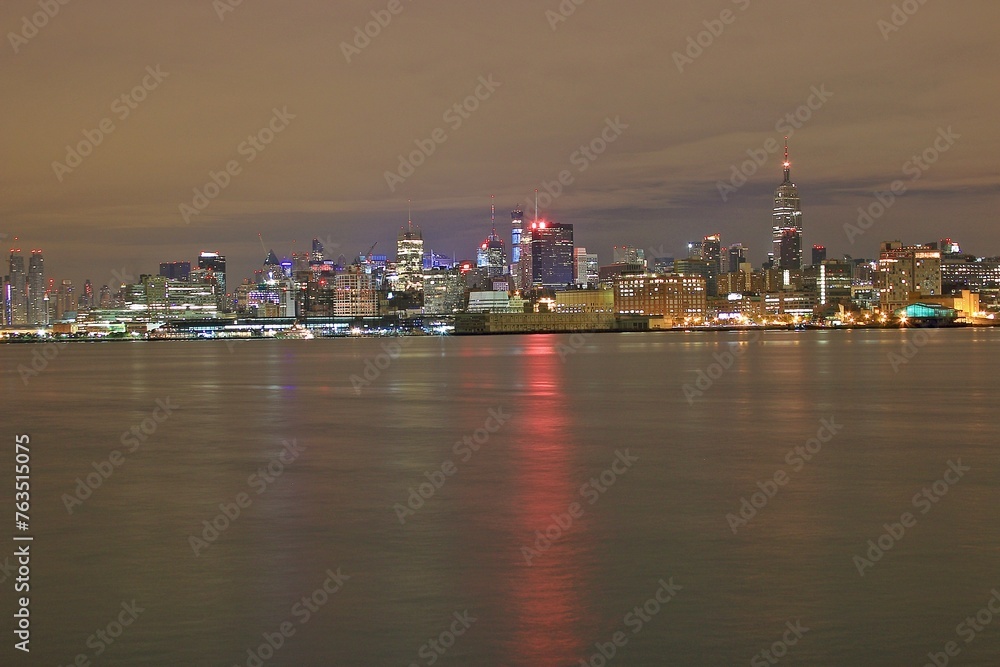 View of skyscrapers along Hudson River in financial district of Manhattan. Skyline of downtown Manhattan at night