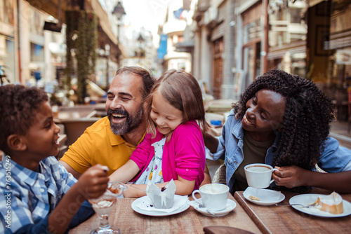 Happy multiethnic family enjoying time at a cafe together © Vorda Berge