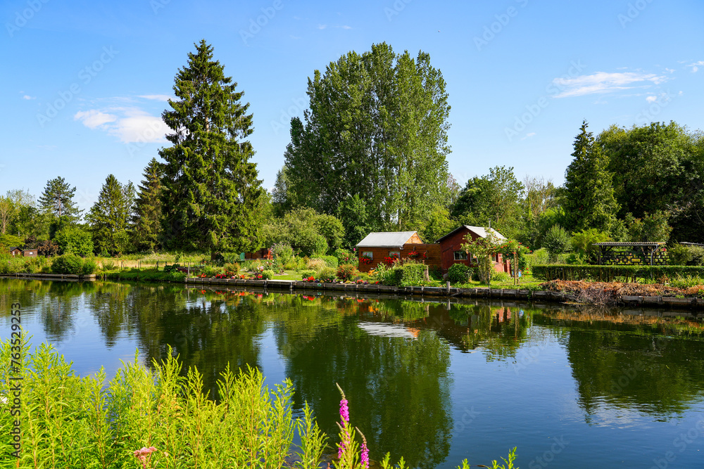 Garden sheds built on an island surrounded by the waters of the River Somme in the Hortillonnages of Amiens in Picardy, France Garden sheds built on an island surrounded by the waters of the River Somme in the Hortillonnages of Amiens in Picardy, France