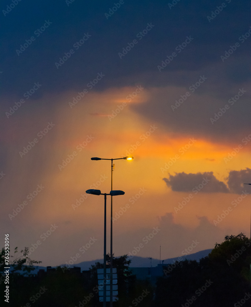 Naklejka premium Streetlamp Amidst Approaching Storm