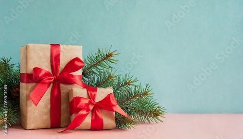 christmas themed still life photo with presents fir branches and empty space depicting winter holidays isolated pastel background copy space © Charlotte