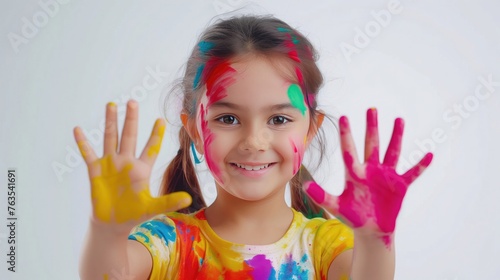 Happy Holi Greeting - Cute little Indian girl with colourful hands  isolated over white background