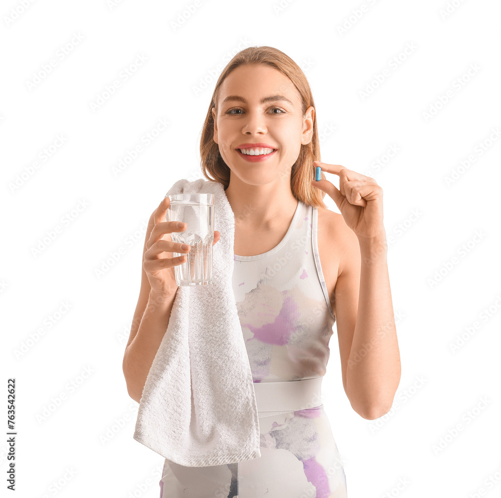 Sporty young woman with vitamin supplement and glass of water on white background Sporty young woman with vitamin supplement and glass of water on white background