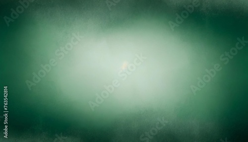 dark and light green background with soft blurred texture design abstract blurry green christmas background with light center and dark borders