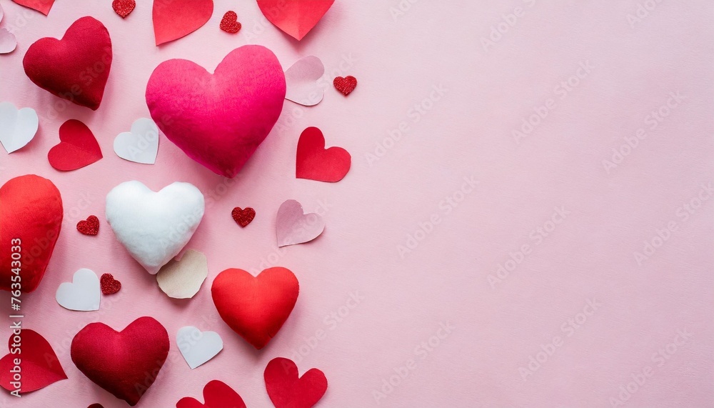 valentine day background of many different paper hearts on pink soft background