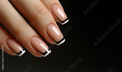 Creative french nail art on a black background. Close up, well-groomed female hands. Copy space, place for signature.