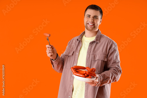 Young man with plate of tas...