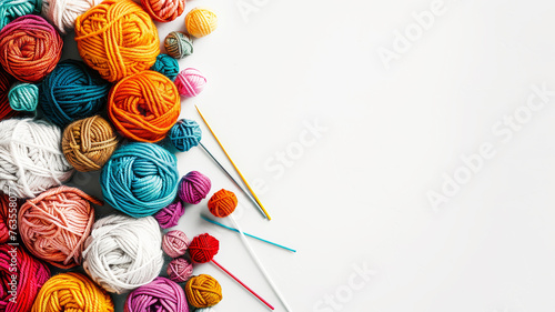 Colorful balls of yarn and knitting needles isolated on white background.