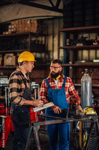 Craftsmen developing new business plan while going through their notes