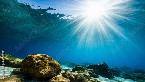 sun shining light in blue clearly deep water sunbeams illuminate the blue underwater sea scene background © Mac