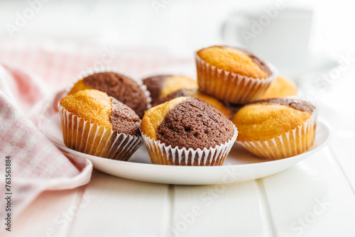 Close Up of a Muffina on plate on a white Table