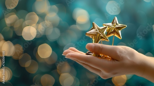 A hand gesture holding five golden star awards  representing success in business or the recognition of personal talent