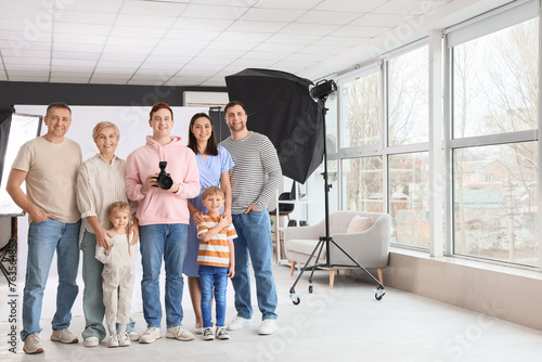 Male photographer with big family in photo studio