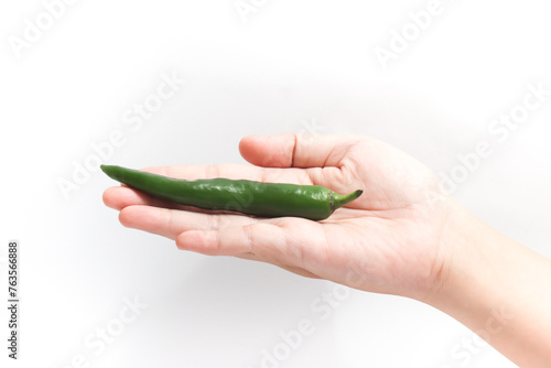 Green hot chili pepper in open hand isolated on white background clipping path