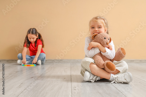 Little girls with toys near...